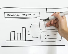 A person writing business plan on white board